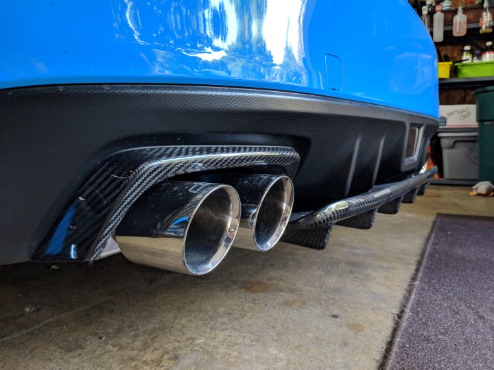 Carbon fiber exhaust bezels and lower diffuser